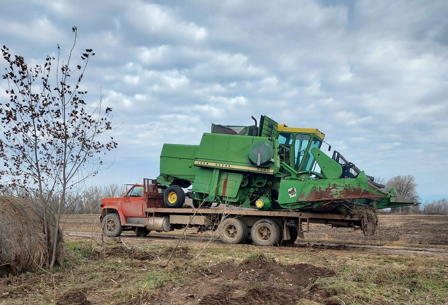 Machinery being towed on truck and trailer