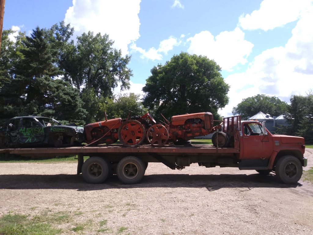 Junk vehicles being hauled on trailer